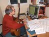 picture 2 :Ganesh composes in front of computer with the 6 string guitar (built by the luthier Alan Wilcox) 2