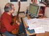 picture 3:Ganesh composes in front of computer with the 6 string guitar (built by the luthier Alan Wilcox) 3